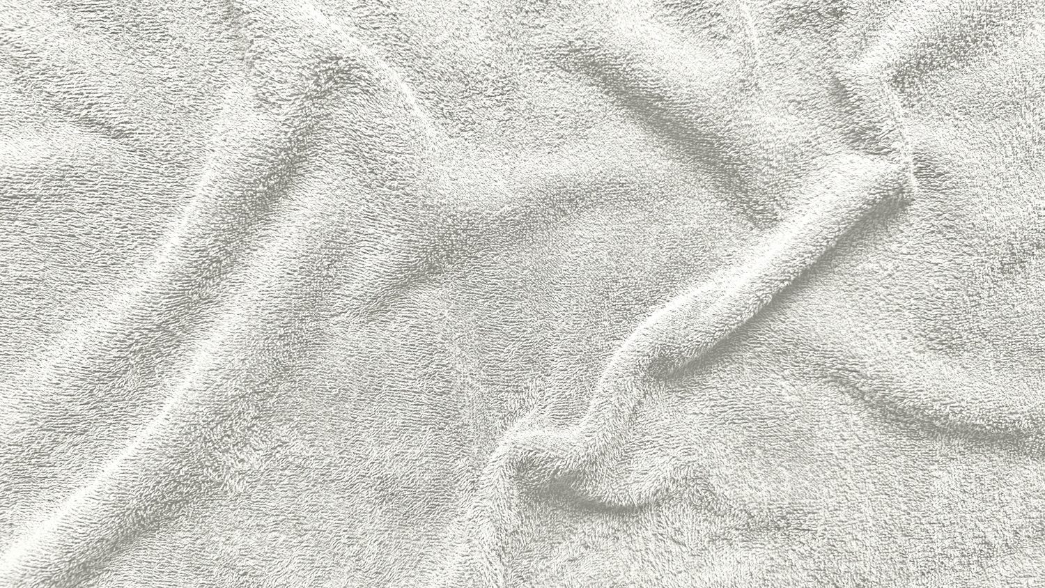 Close-up of white terry towel fabric showing the looped pile